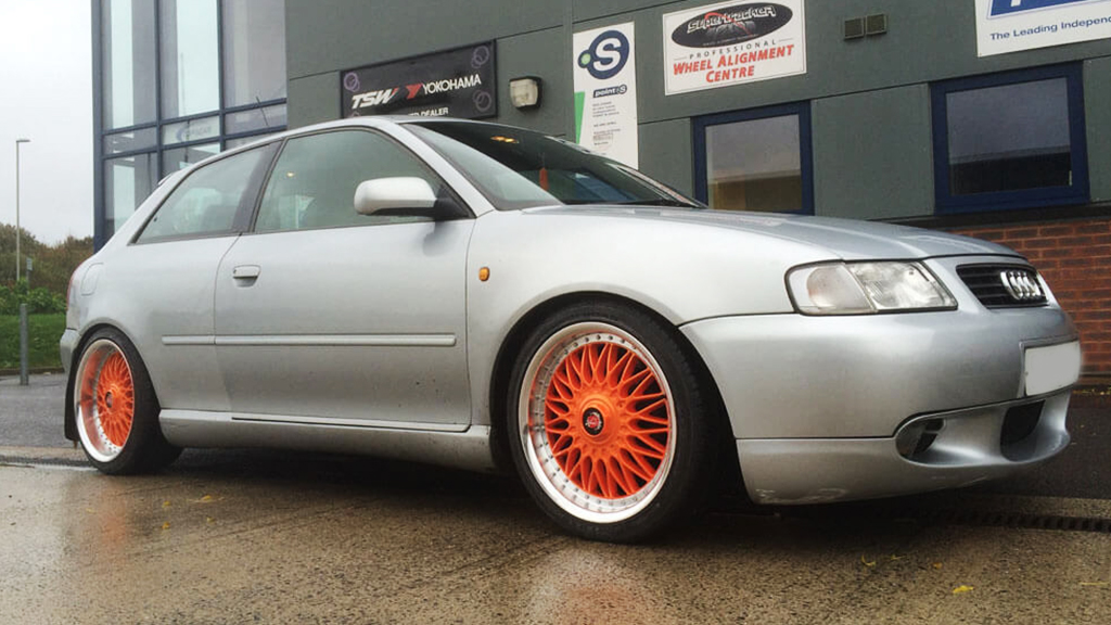 silver car orange wheels